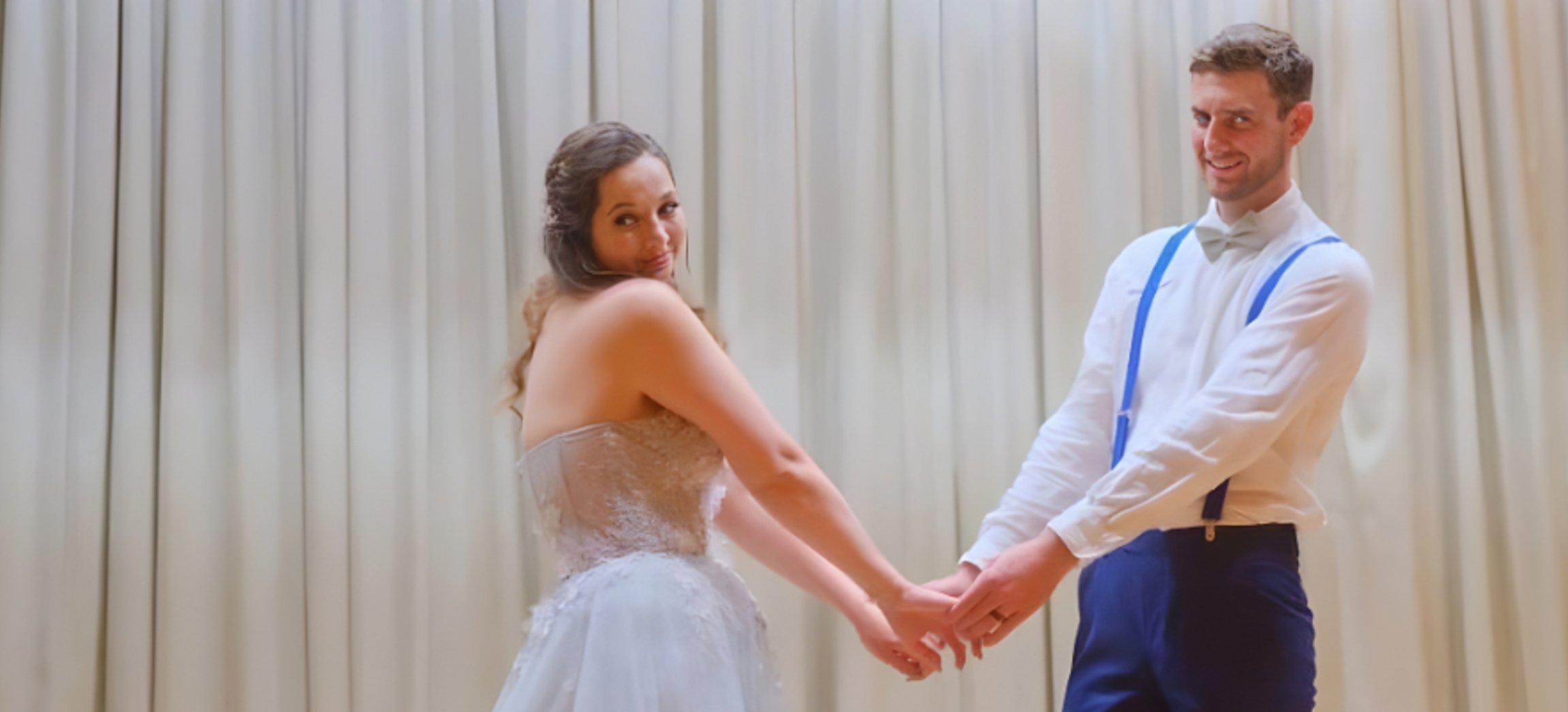 Bride and groom posing with Starry Night Photo Booth backdrop