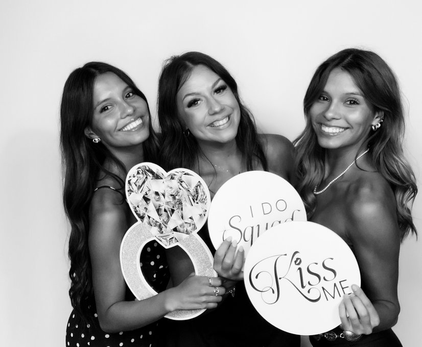 Guests smiling with props in photo booth